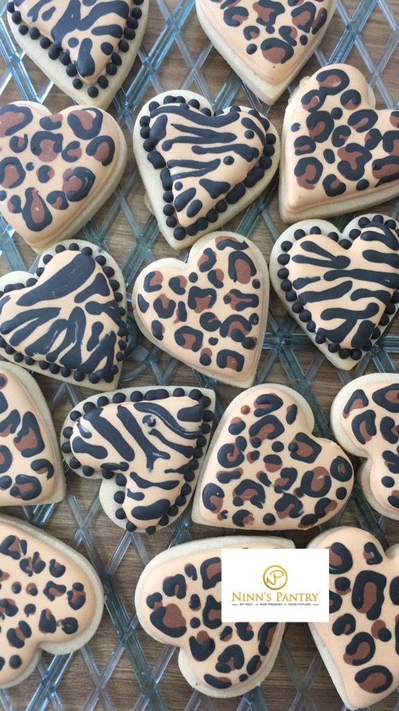 decorated cookies in the shape of hearts and leopard print