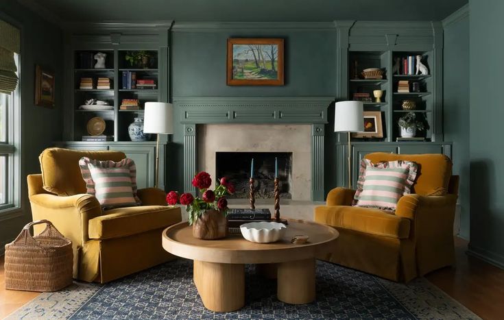 a living room with two chairs and a coffee table in front of a fire place