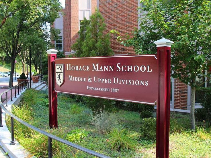 a sign for the horse mann school middle and upper division is displayed in front of a building