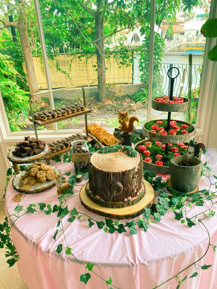 a table topped with lots of cakes and desserts