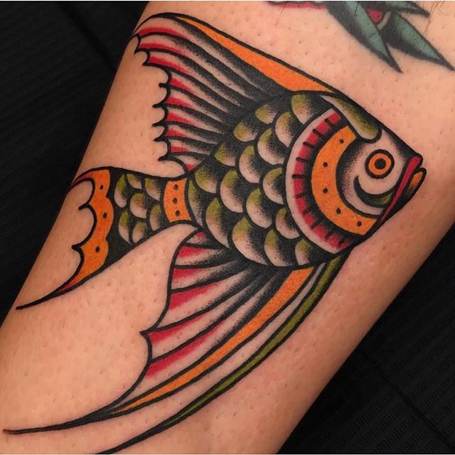 a colorful fish tattoo on the leg