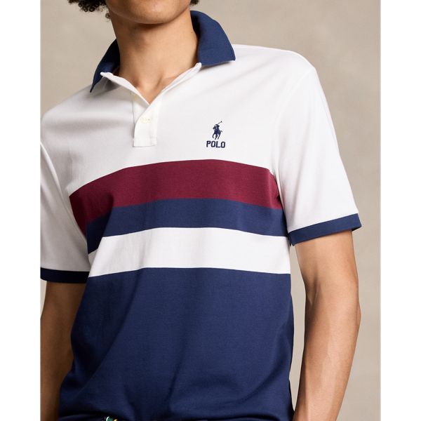 An American style standard since 1972 the Polo shirt has been imitated but never matched. Over the decades Ralph Lauren has reimagined his signature style in a wide array of colors and fits yet all retain the quality and attention to detail of the iconic original. This color-blocked version is made with luxe cotton interlock that features an ultrasoft finish. Casual Cotton Shirt With Signature Stripes, Fitted Cotton Tops With Signature Stripes, Casual Collared Tops With Signature Stripes, Cotton Tops With Signature Stripes, Classic White Shirt With Signature Stripes, Casual Blue Shirt With Signature Stripes, Casual White Shirt With Signature Stripes, Classic Multicolor Short Sleeve Shirt, Classic Fitted Tops With Signature Stripes