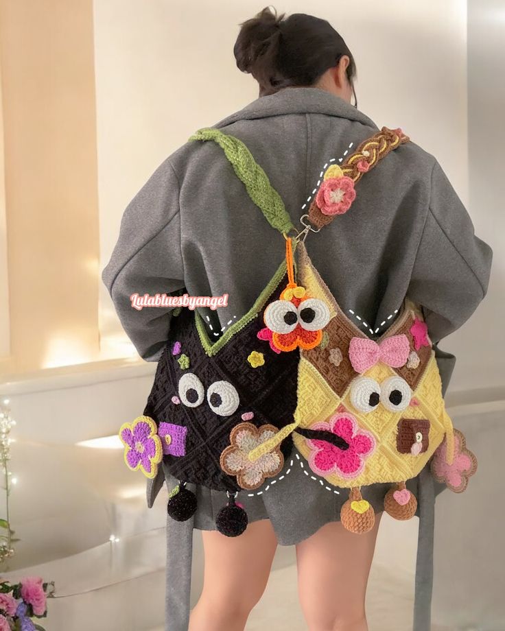 the back of a woman's jacket with owls and flowers on it, while she is standing in front of a toilet