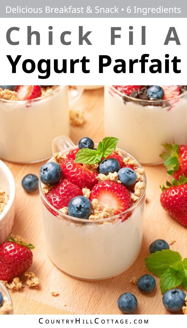 yogurt parfait with fresh berries and granola in the middle on a wooden table