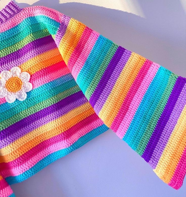 a colorful crocheted sweater with a flower on it