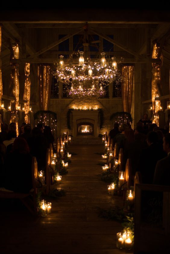 a church filled with lots of lit candles