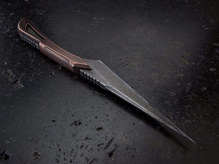 a knife that is laying on the ground with it's blade still attached to it