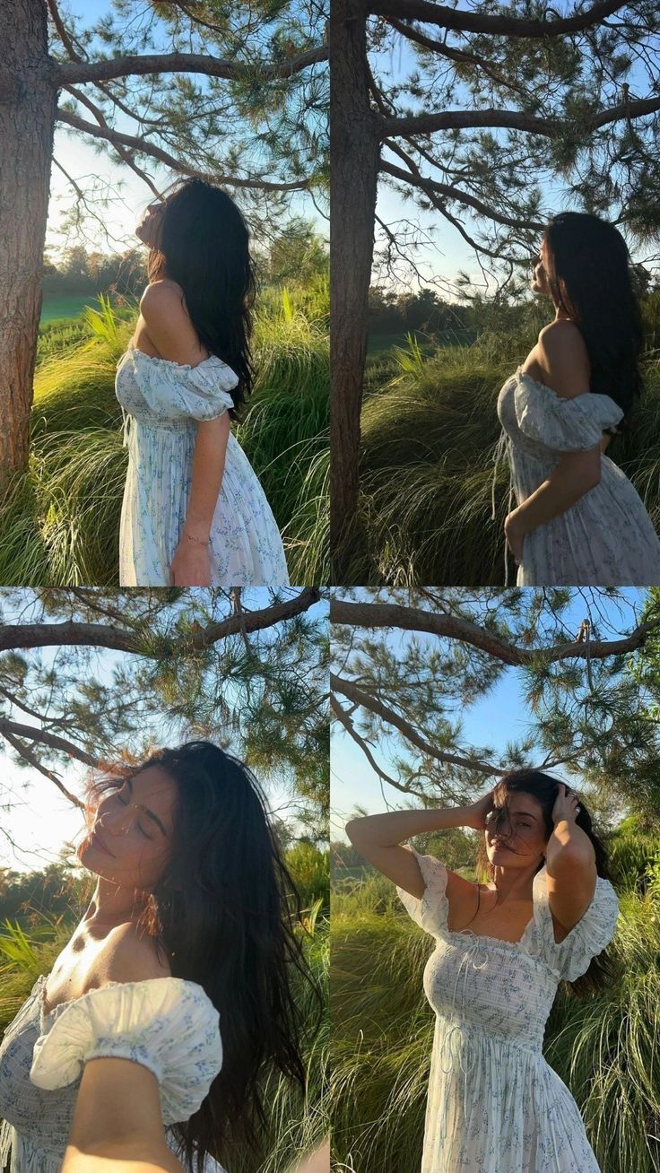 a woman wearing a white dress standing next to a tree