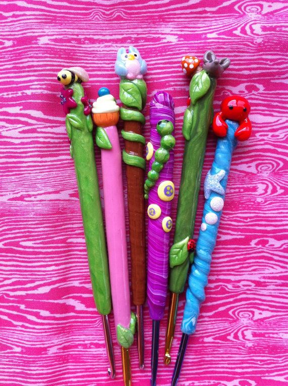 four colorful toothbrushes are lined up on a pink surface with different designs and colors