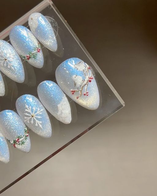 dreamylittlenails ✨ by angel on Instagram: "One week left until Christmas! ❄️   Here is the rest of my winter nail design with snow fairy birds inspired from my recent trip to Hokkaido. In case you missed it, last week I also posted a bts reel on painting the tree using @dvok_us canvas textured gels in top of @yogo.mayo_usa holy moly blue cat eye polish. Swipe over to see how they look under different lighting and on video! 🥰 The hardest thing about cat eye nails is taking photos of them 😅.      ✦ @yogo.mayo_usa holy moly blue  ✦ @dvok_us canvas     #sweetienailstyles #winterdesigns #cutenails #3dnailart #christmasnails #xmasnails #holidaynails #glitternails #cateyenails #winternails" Snowglobe Nails, Snow Globe Nails, Cat Eye Polish, Winter Nail Design, Blue Cat Eye, Snow Fairy, Eye Nails, Holy Moly, Cat Eye Nails