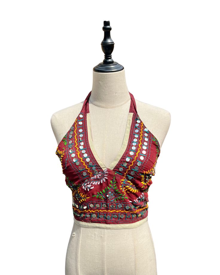 This vibrant, hand-embroidered bikini halter top offers stylish Boho-inspired fashion with its colorful threads and sequin embellishments. Paired with jeans or a skirt, this is the perfect summer top to stand out in and make a statement. The lining is a contrasting color to give it a unique, eye-catching look. One Size Made in India Care Instructions: Dry clean only Hawaii Fits, Girl In The Mirror, Boho Halter Top, Colorful Threads, Vintage Gold Watch, I Love Gold, 70s Inspired Fashion, Beach Fits, Senior Trip