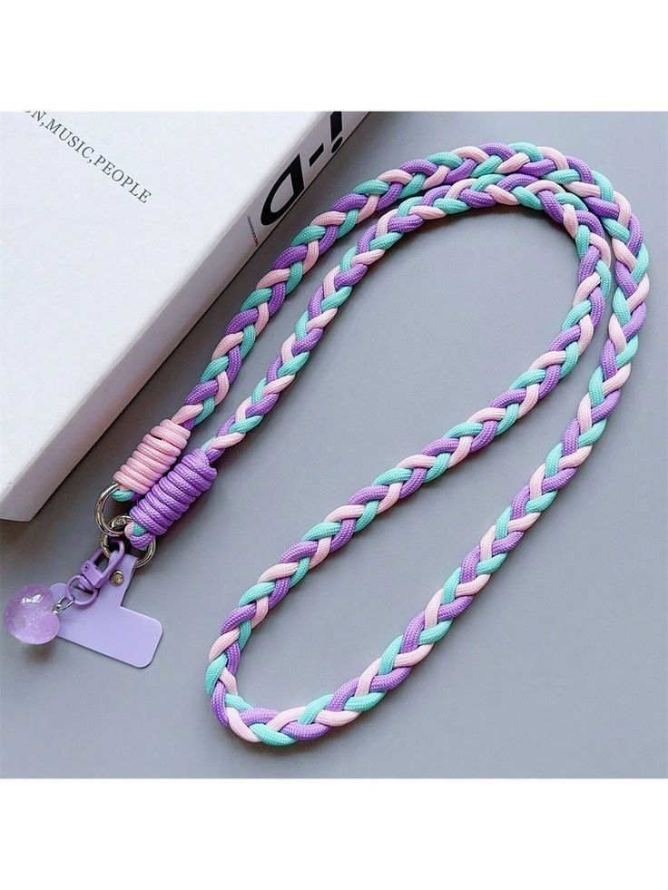 a purple, blue and pink lanyard with a white tag on the end of it