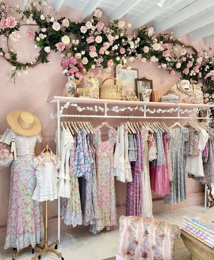 a clothing store filled with lots of different types of dresses and hats hanging on clothes racks