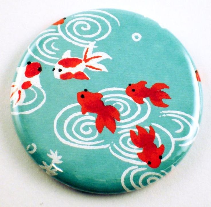 a blue button with red fish on it