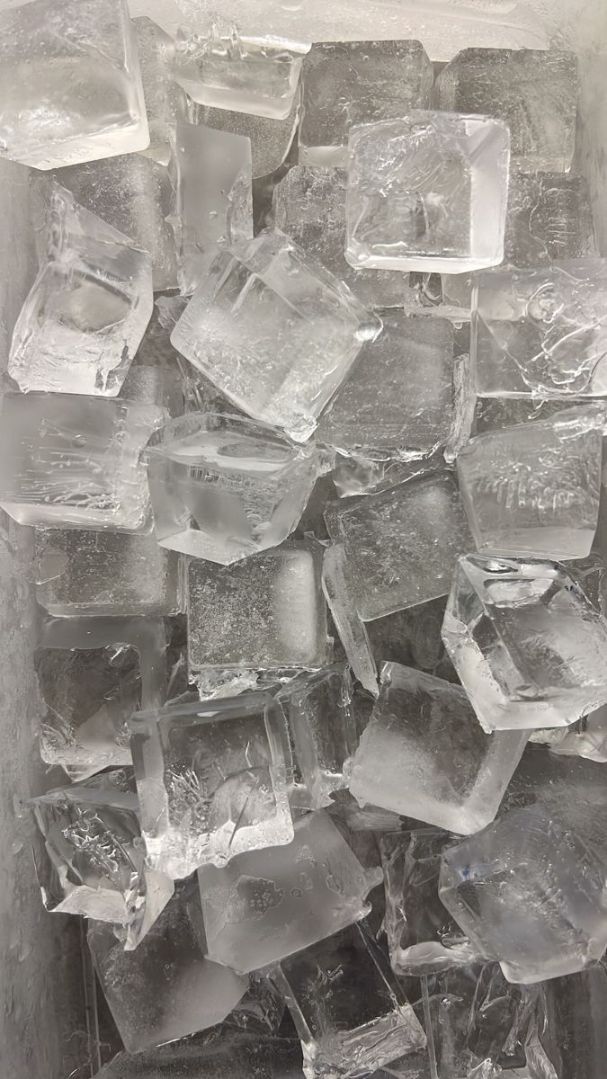 ice cubes are piled together in an ice box