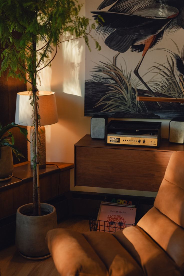 a living room with a couch, chair and television on top of a wooden table