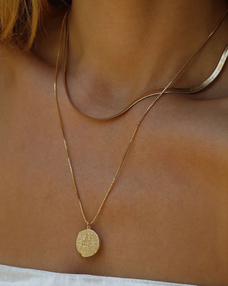 The Kefi necklace is a gold filled medallion engraved with ancient Greek writing and imagery. In Greek, Kefi means fun, and people use it to symbolize something positive or good. When someone mentions the word Kefi, they are referring usually to happiness, passion, joy, and as such, this necklace was given the name so that the wearer can be literally surrounded by happiness and joy. Beautiful piece to wear individually or layered! Chain 24K Gold Filled Square Box Chain Length: 20” inches Pendant Gold Coin Pendant Necklace For Blessing, Spiritual Gold Plated Engraved Medallion Necklace, Spiritual Gold Plated Engraved Coin Necklace, Symbolic Gold Hammered Necklace, Everyday Gold Engraved Medallion Necklace, Spiritual Gold-plated Engraved Coin Necklace, Spiritual Engraved Gold-plated Medallion Necklace, Spiritual Engraved Gold Plated Medallion Necklace, Symbolic Gold Engraved Coin Necklace