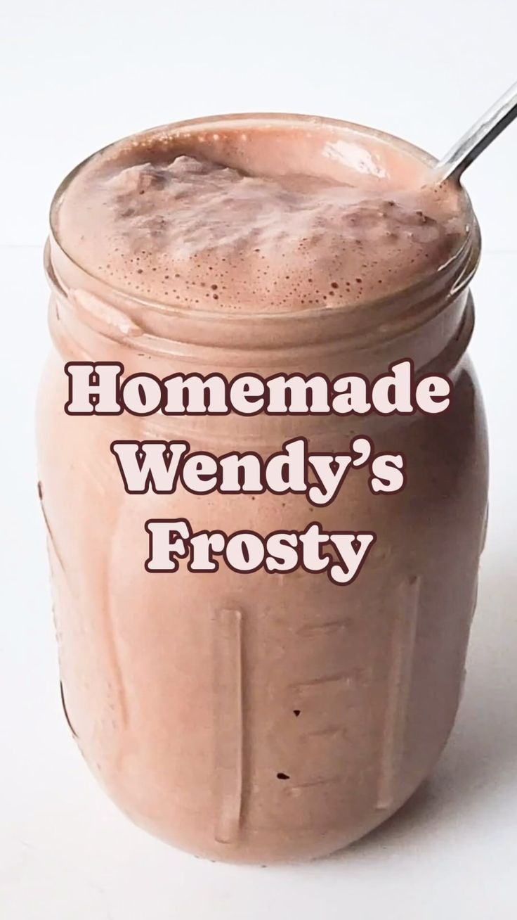 a chocolate smoothie in a mason jar with a straw sticking out of the top