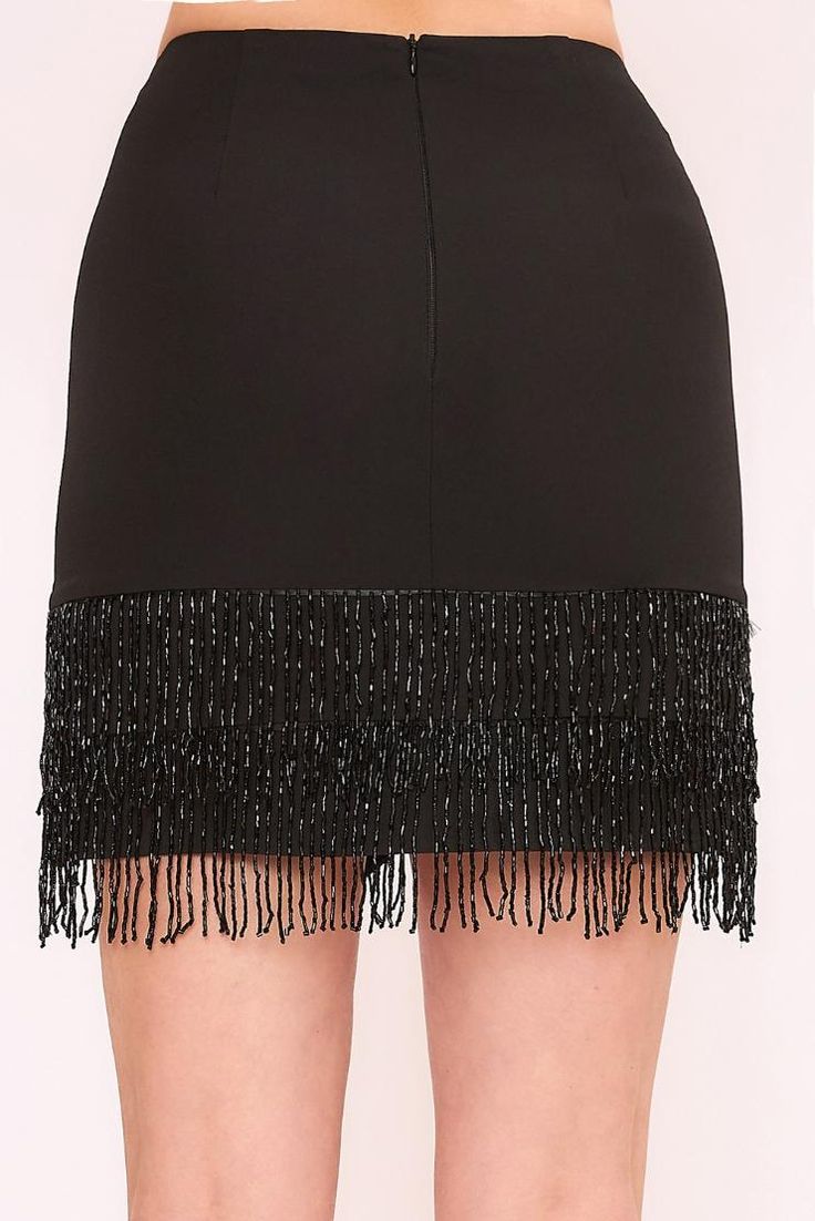 Boogie down in this jewel-encrusted fringe skirt. Move and shake in style with this sleek black skirt that's adorned with sparkly gems. Bedazzle the crowd with your funky moves! Black Woven Lined High-low hem Jewel fringe Zipper closure