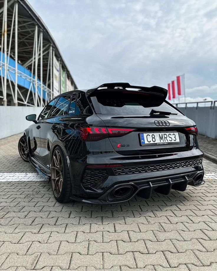 an audi car parked in front of a building