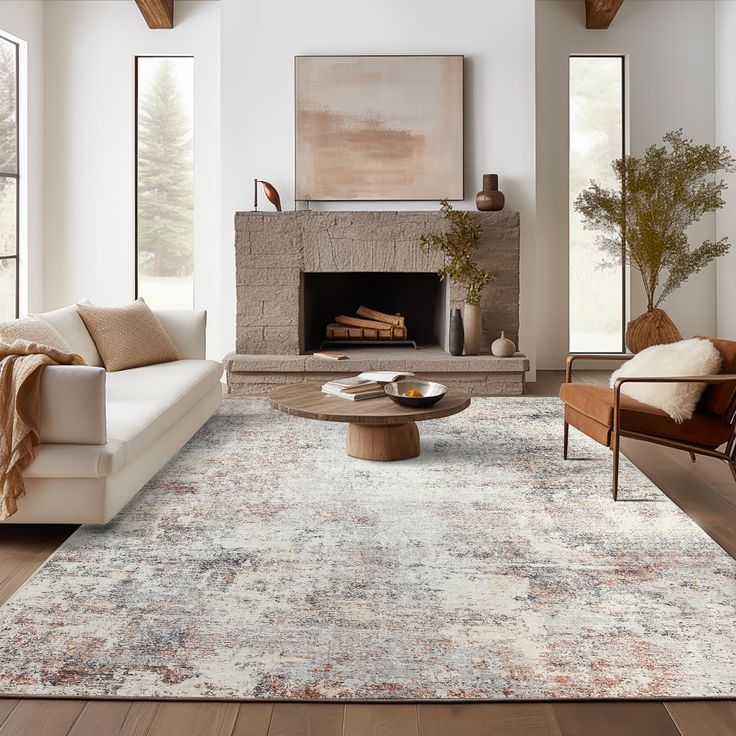 a living room filled with furniture and a fire place in the middle of the room