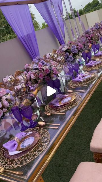 the table is set with purple and gold place settings