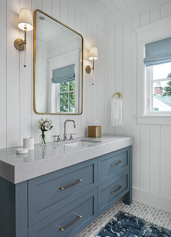 a bathroom with two sinks and a large mirror