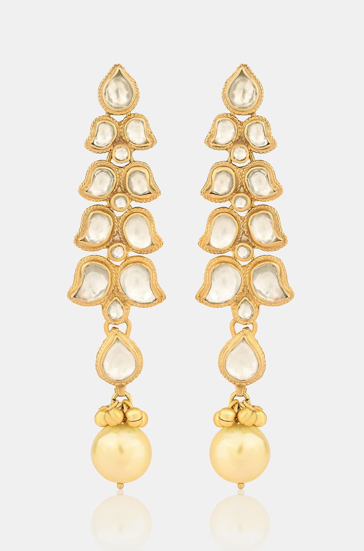 Elevate your elegance with our Kundan Earrings, showcasing beautifully crafted kundan motifs in a unique pattern, accentuated with a pearl drop for a contemporary touch. Crafted with precision, these earrings make a stunning statement for any occasion Finish: 22KT Gold Plating Material: Silver, Copper Alloy, Kundan Color: Gold Size: One Size Closure Type: Push Back Box Contains: 1 Pair of Earrings Elegant Kundan Jhumkas With Gota Work, Elegant Chandelier Earrings With Gota Work For Wedding, Elegant Bridal Earrings With Gota Work For Festive Occasion, Elegant Festive Jhumkas With Gota Work, Elegant Jhumkas With Gota Work For Diwali, Elegant Chandbalis With Gota Work For Celebrations, Traditional Kundan Earrings With Elegant Design, Pearl Drop Earrings For Reception, Festive Elegant Bridal Earrings With Gota Work