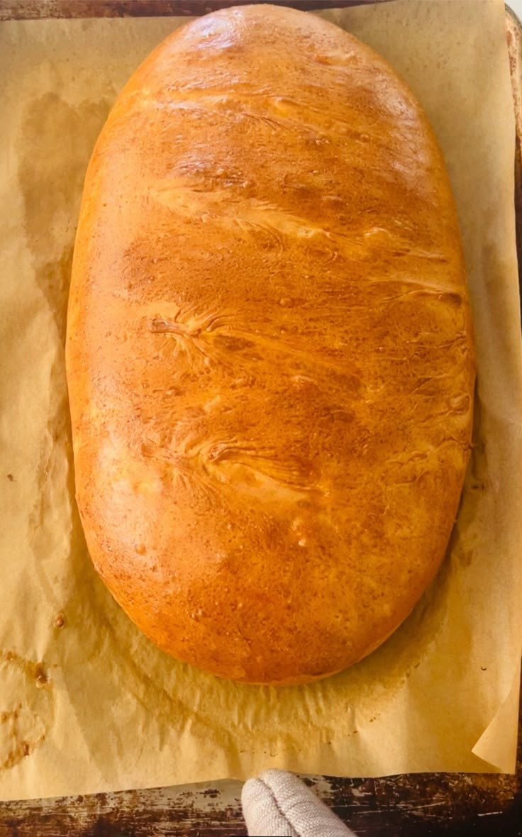 a loaf of bread sitting on top of a piece of wax paper