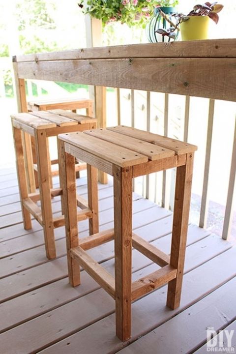 three wooden stools sitting on top of a porch