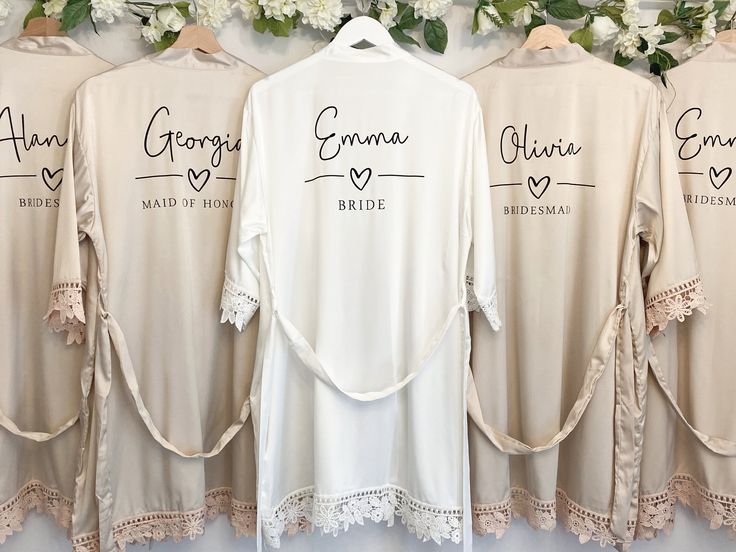 the bride and groom's shirts are hung up next to each other with their names on them