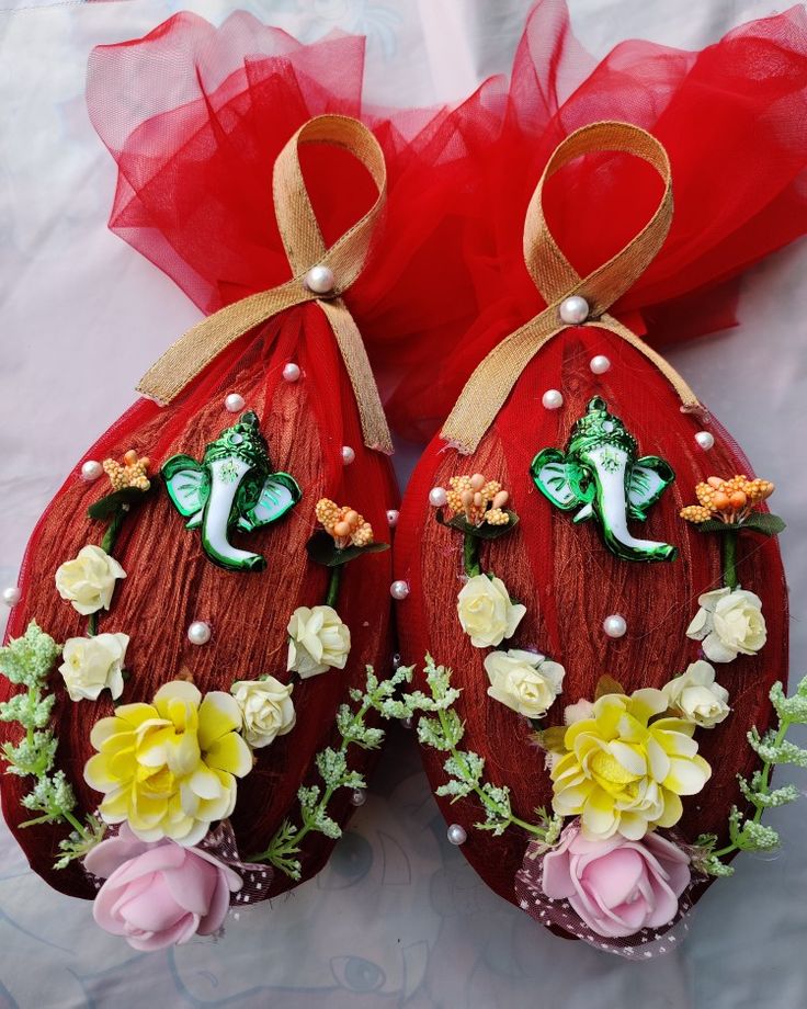 two red eggs decorated with flowers and butterflies