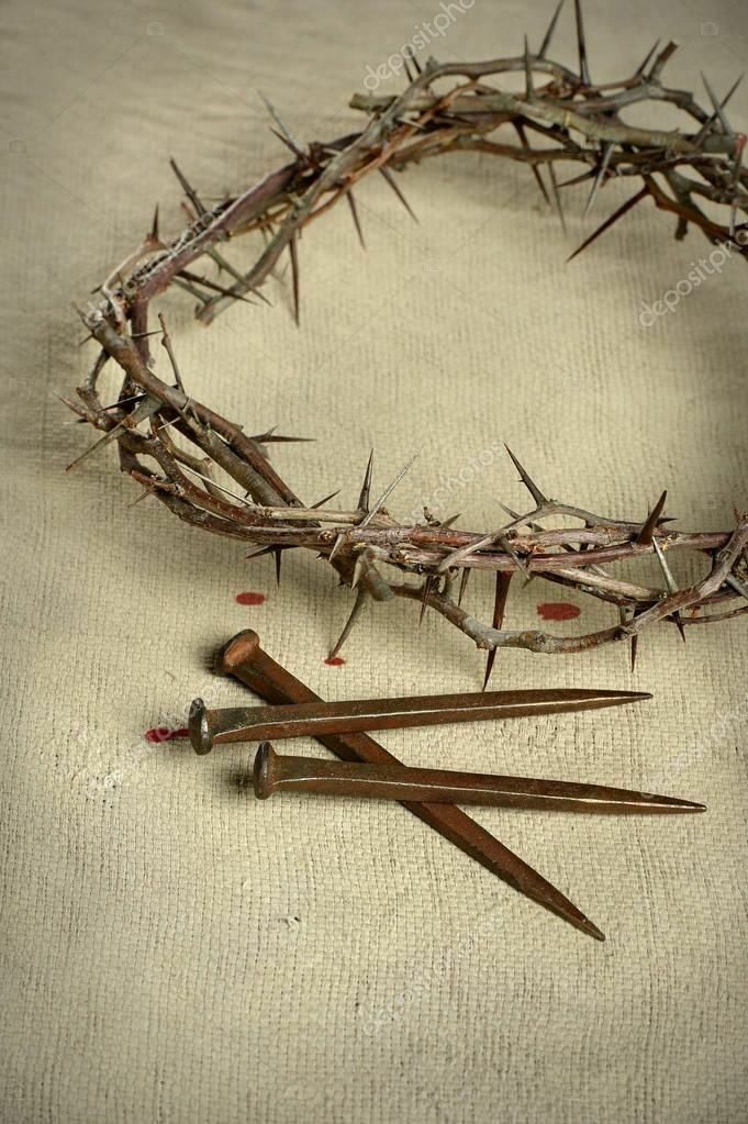 a crown of thorns with scissors and nails laying on the ground next to it