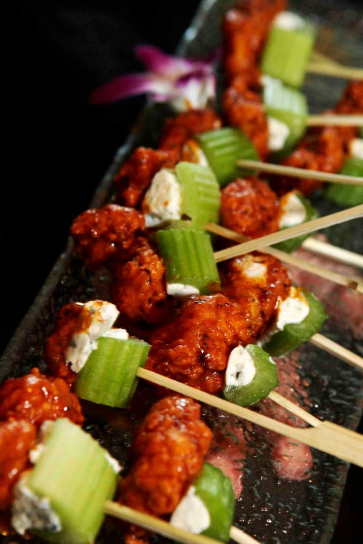 the food is being served on skewers with celery