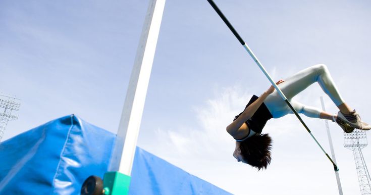 a person doing tricks on a pole in the air with a pole attached to it