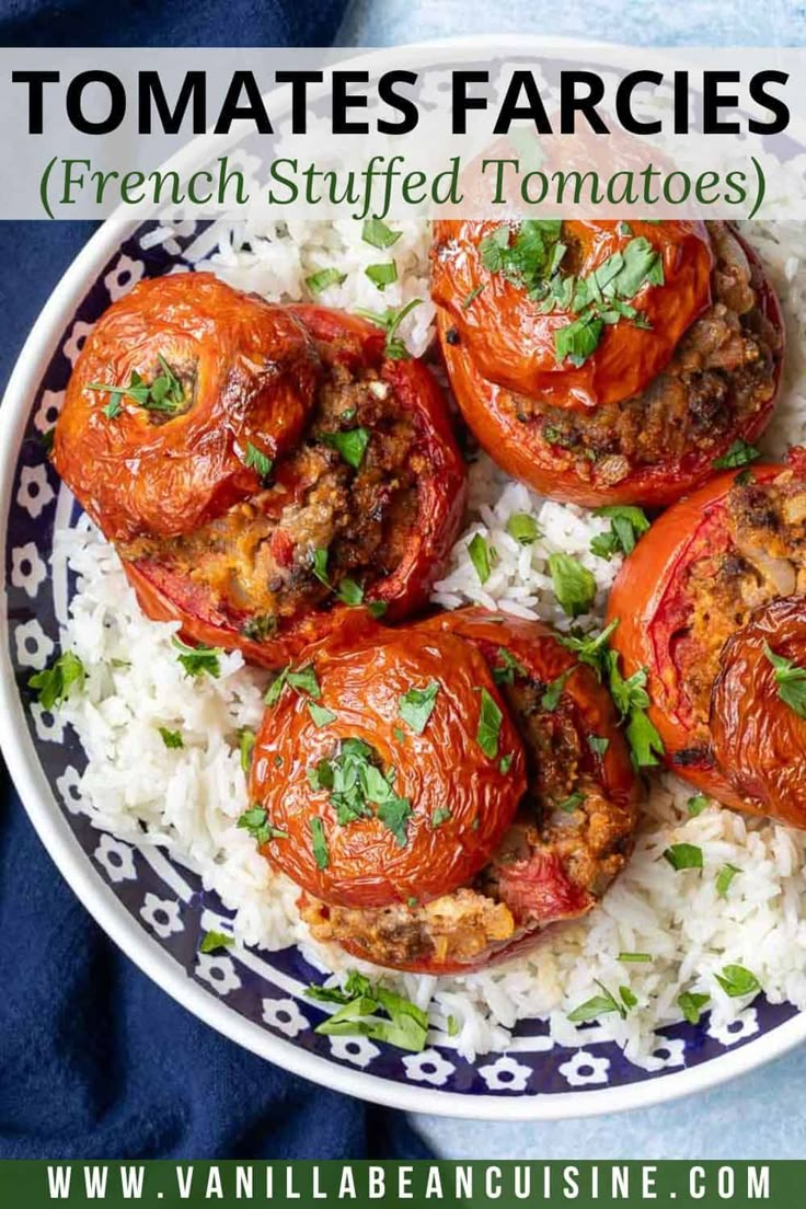 tomatoes stuffed with meat and topped with parsley on top of white rice in a bowl