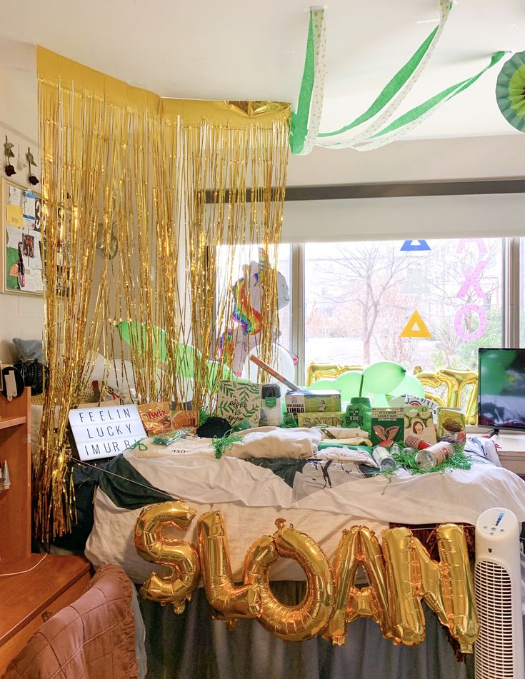 a party table with balloons and streamers in the shape of the word socam