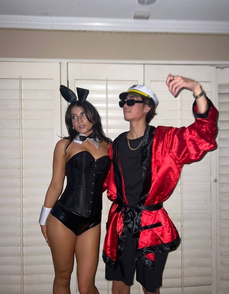 two people dressed in costumes posing for the camera