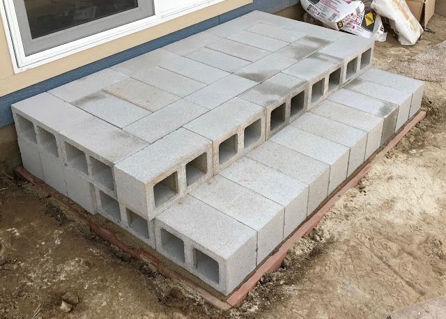 some cinder blocks are laying on the side of a house that's being built