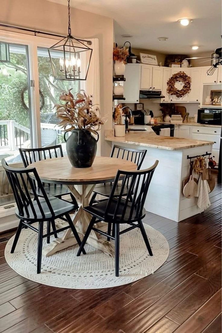 a dining room table with chairs and a potted plant on top of the table