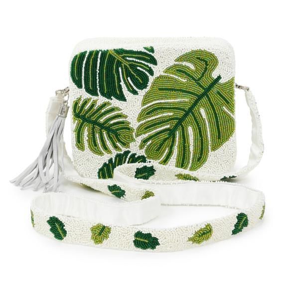 Paige Bag – Green LeafFully Beaded Crossbody Bag – customized with Green Monstera LeavesStructured silhouette measures 8 ″ wide x 6″ tall with 2″ gusset and is large enough to carry all sizes of the iPhone and other evening essentials.Satin-lined with a small pocket for credit cards and zippered closure.Fully Beaded Cross Body Length Strap with 24″ dropIn stock quantities are listed and will ship immediately.  Please allow four weeks for shipment of back ordered bags. Beaded Shoulder Bag For Shopping, Beaded Travel Pouch Bag, Beaded Pouch Shoulder Bag For Travel, White Beaded Crossbody Bag, Beaded Crossbody Shoulder Bag For Travel, White Beaded Shopping Bags, Summer Beaded Pouch Bag, Green Beaded Pouch Shoulder Bag, Green Beaded Bag For Summer