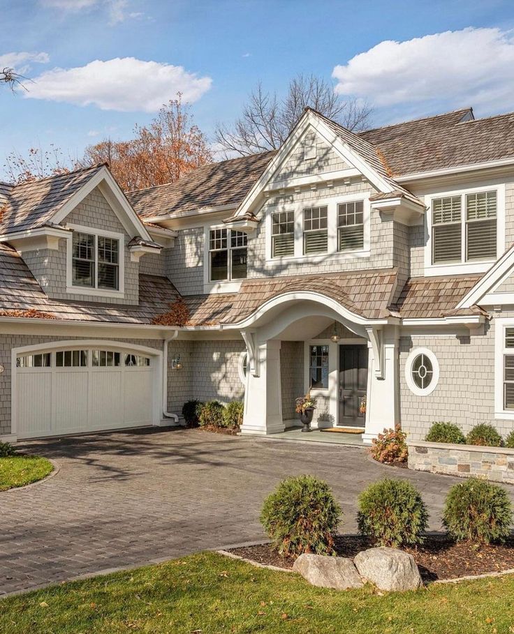 a large house with two car garages in the driveway