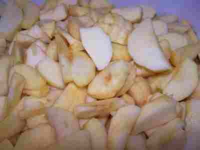 sliced apples are piled up in a pile