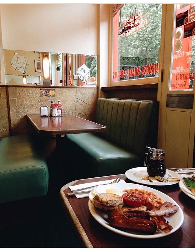 two plates of food sit on a table in front of a window at a restaurant