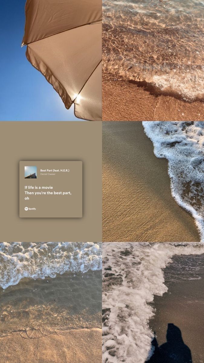 an umbrella sitting on top of a sandy beach next to the ocean with waves coming in