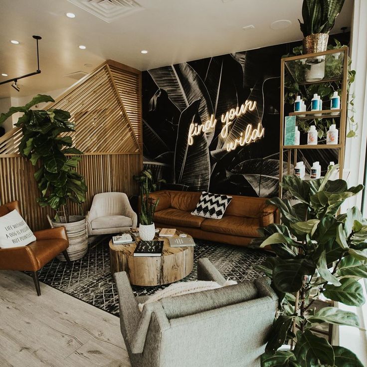 a living room filled with furniture and plants