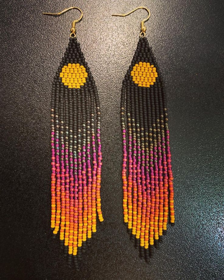 two pairs of beaded earrings with yellow, pink and orange beads hanging from them