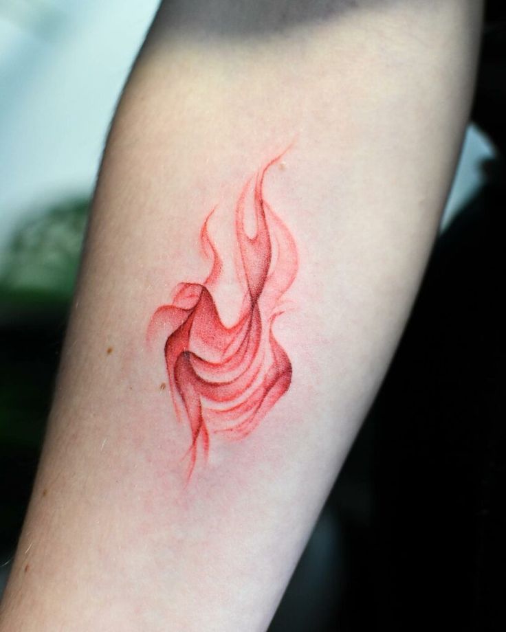 a red tattoo on the arm of a woman