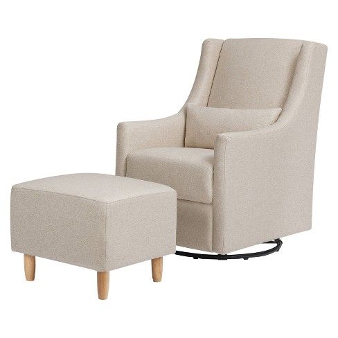 a white chair and ottoman sitting next to each other