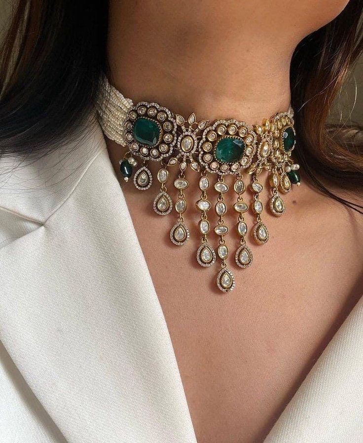 This Sabyasachi-inspired green uncut Kundan Victorian choker set, paired with matching earrings, exudes timeless elegance and sophistication. Crafted meticulously, the choker showcases an exquisite arrangement of uncut green Kundan stones, each carefully selected for their natural beauty and luster. These stones are set in a delicate antique gold frame, reminiscent of the opulent Victorian era, blending classic artistry with contemporary flair. The choker's intricate design features layers of or Luxury Kundan Necklace With 17 Jewels For Celebration, Luxury Kundan Bridal Set In Temple Jewelry Style, Luxury Pista Green Kundan Anarkali Set, Luxury Ornate Kundan Jewelry Sets, Luxury Ornate Kundan Necklace For Formal Occasions, Luxury Kundan Bollywood Pearl Earrings, Luxury Kundan Jewelry Sets For Ceremonial Occasions, Luxury Kundan Jewelry Sets Hallmarked, Luxury Kundan Festive Sets